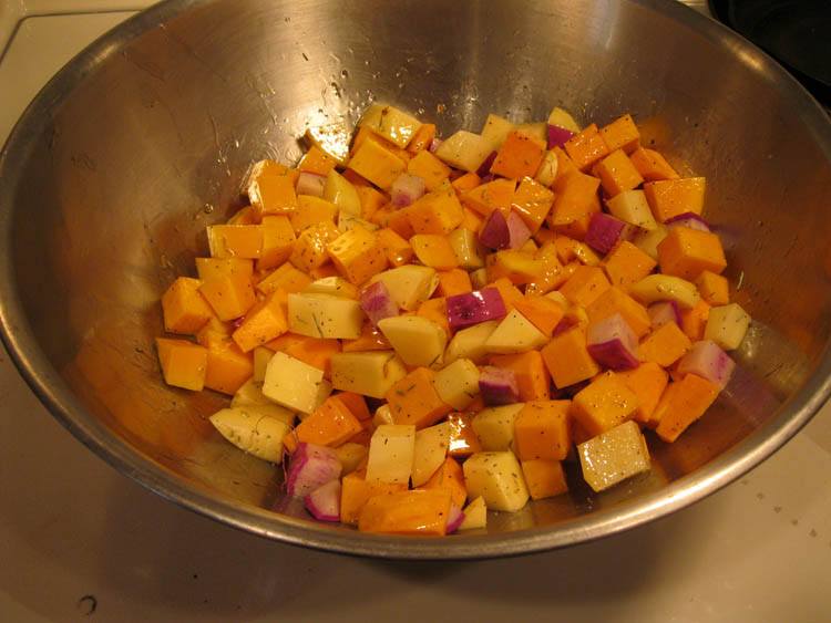 toss roasted vegetables in a bowl